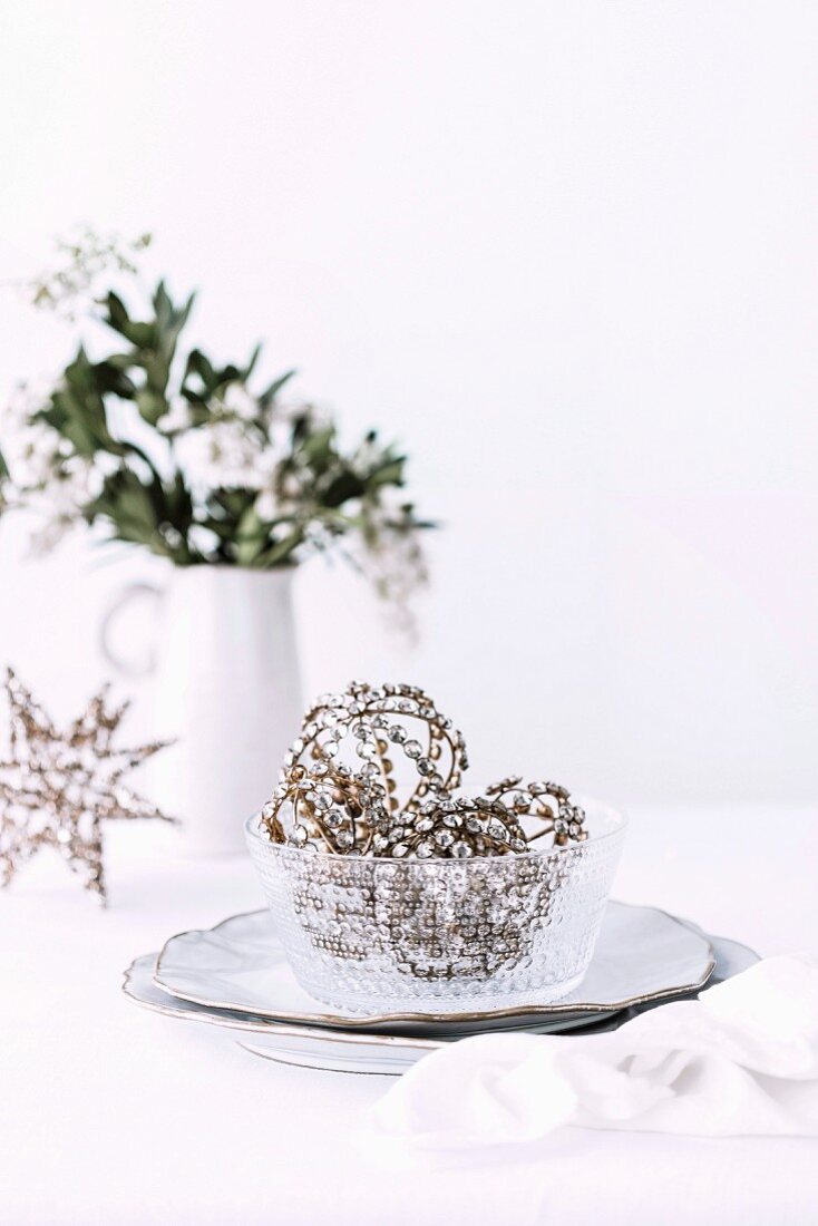 Filigree Christmas balls with rhinestones in a glass bowl