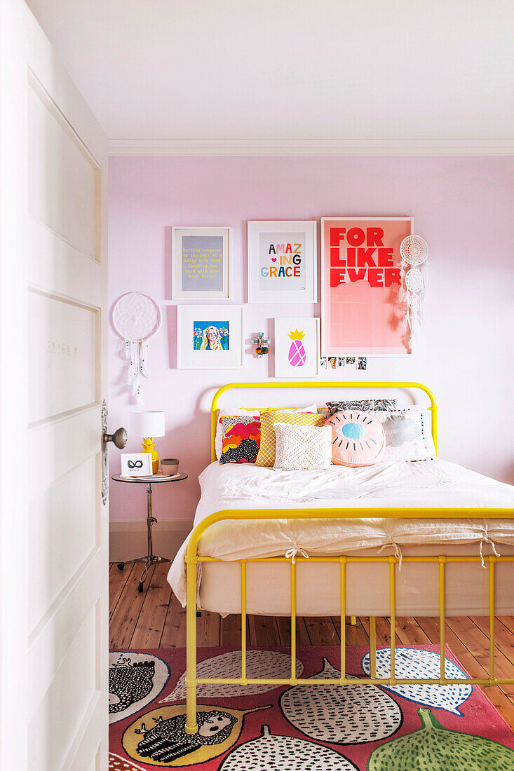 Colorful room with metal bed and framed wall decoration