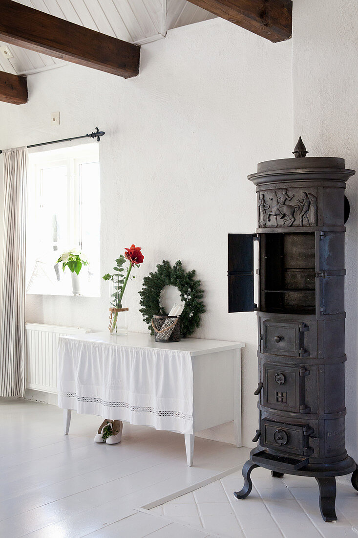 Old cast-iron stove in white country house