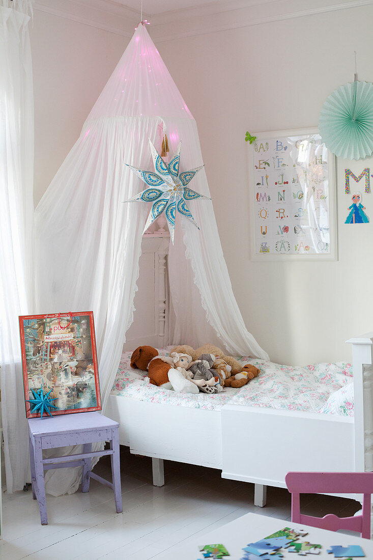 Illuminated canopy above extendable child's bed
