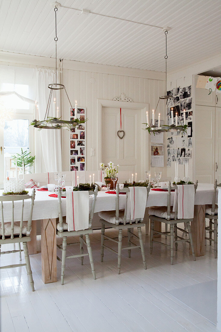 Old wooden chairs around festively decorated dining table