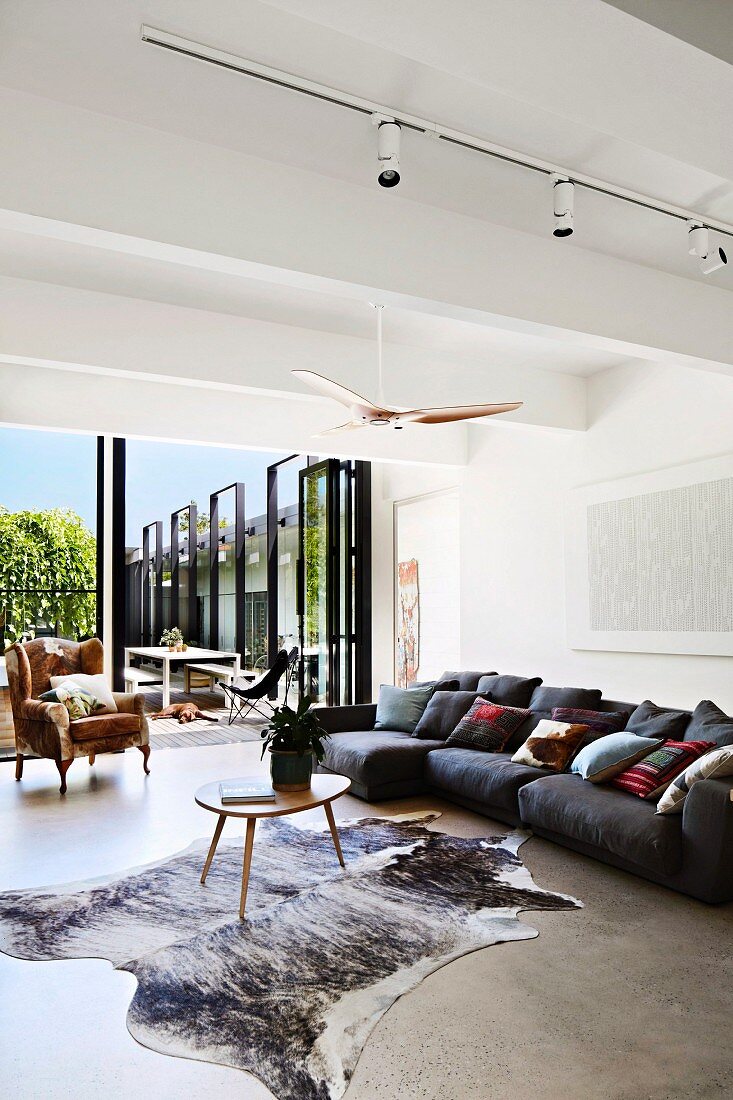 Modern living room with cowhide carpet and terrace