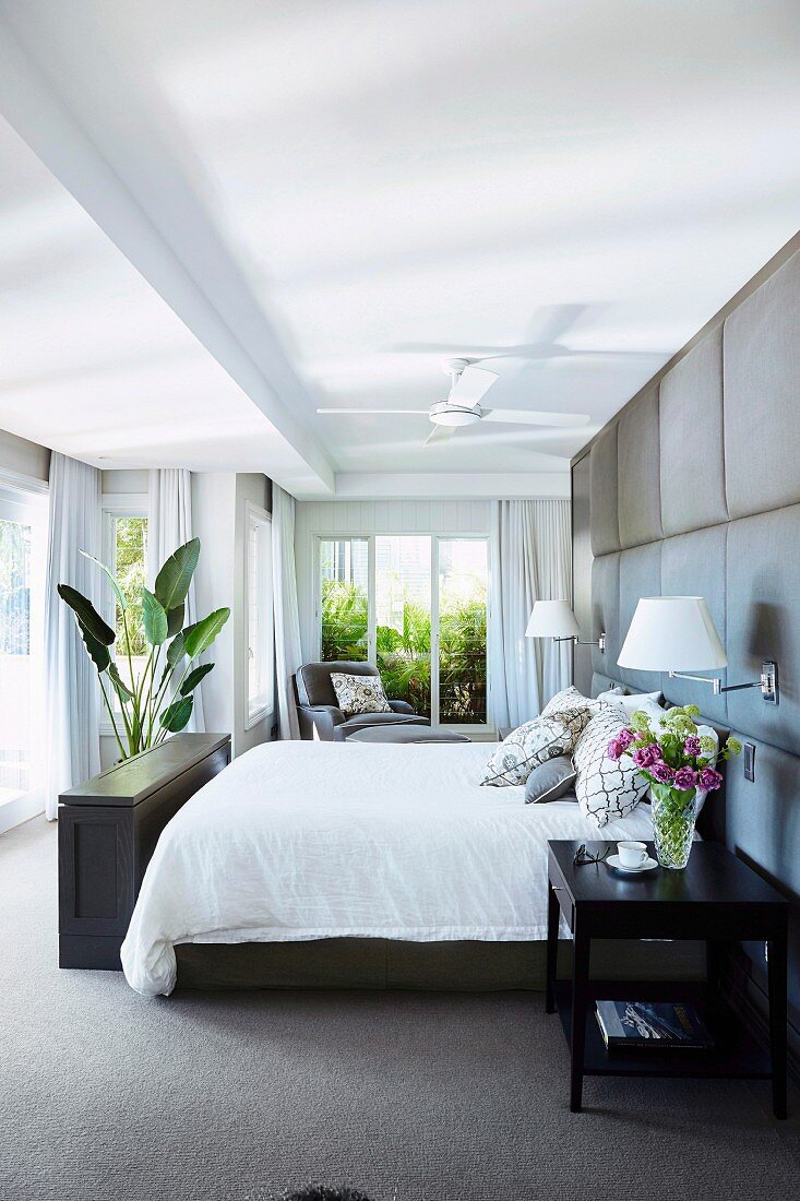 Elegantes Schlafzimmer mit grau gepolsterter Wand
