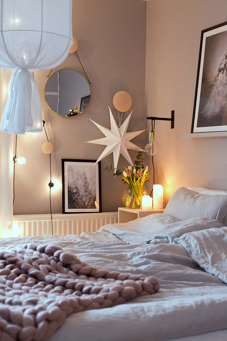 Cosy lighting in bedroom in shades of white and grey