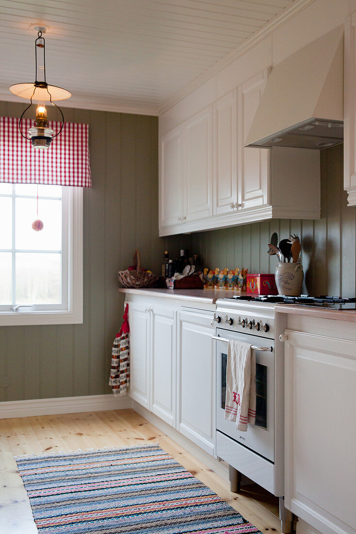 Scandinavian country-house kitchen with board wall painted grey-green
