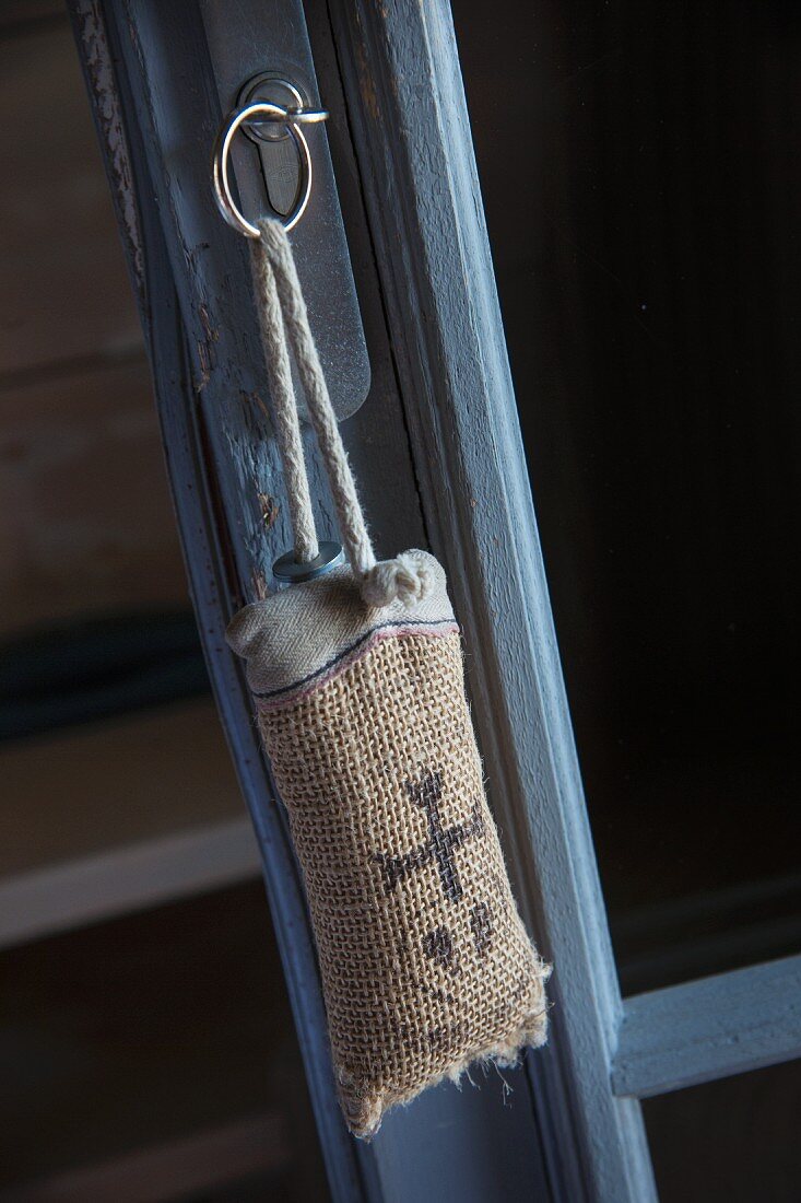Key fob made from printed hessian hung from door
