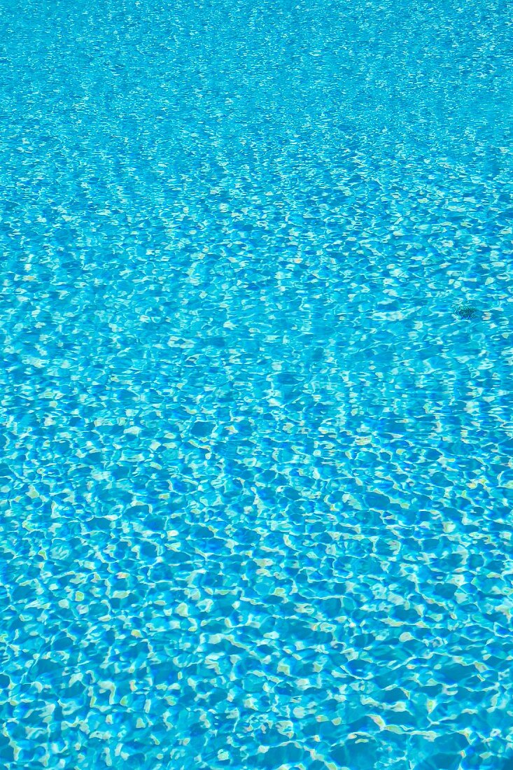 Reflections on water in blue swimming pool