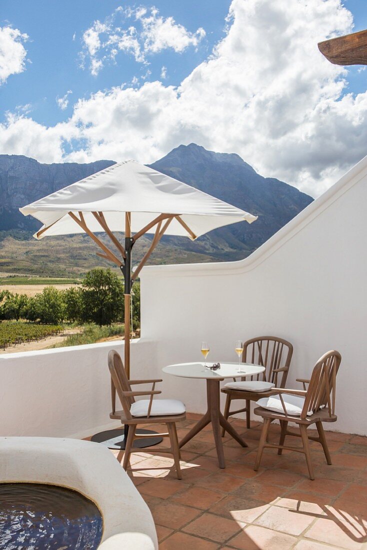 Seating area below parasol and view of mountains