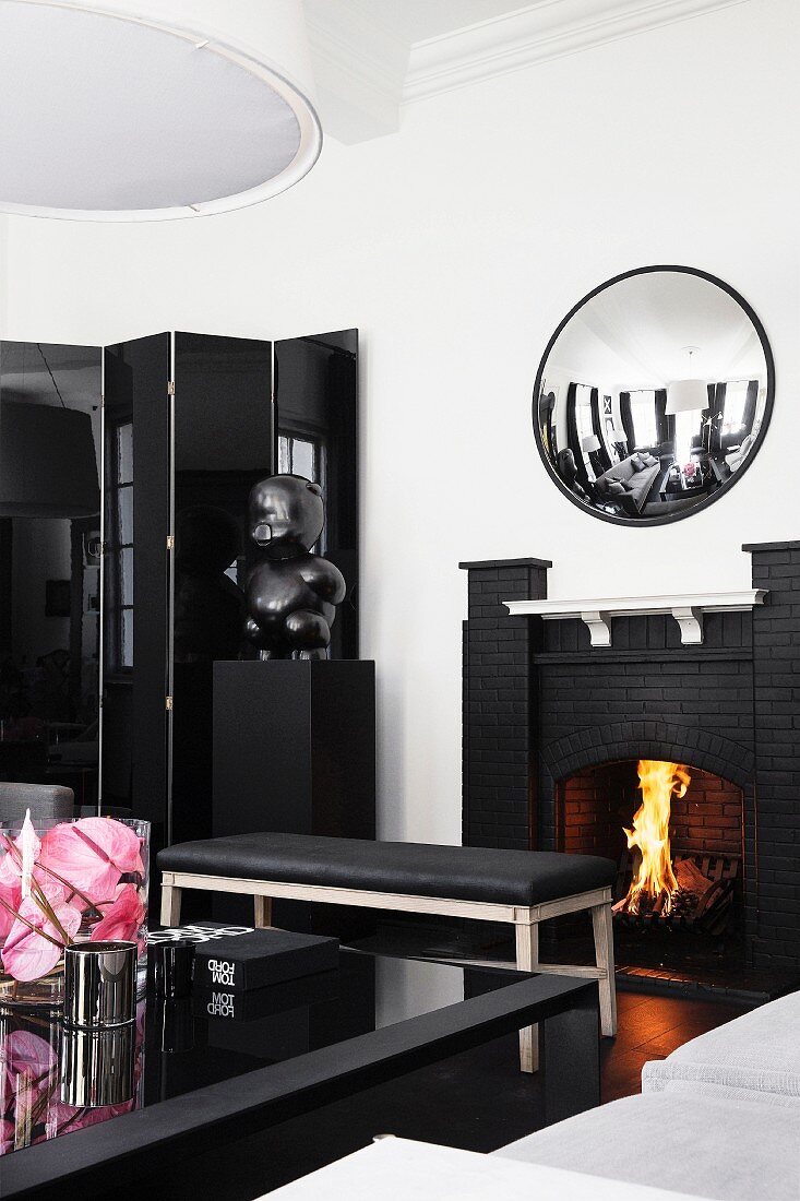 Open fireplace in elegant black and white living room