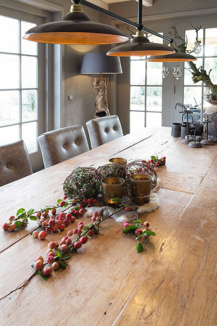 Natural arrangement on wooden table in rustic dining room