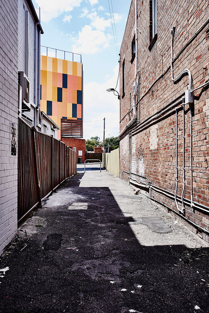 Ramshackle alley between two brick houses