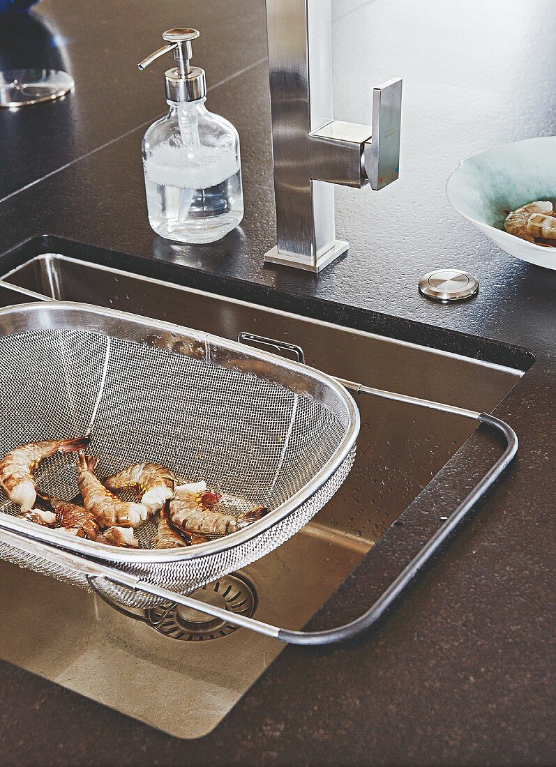 A sink with a stainless steel sink sieve
