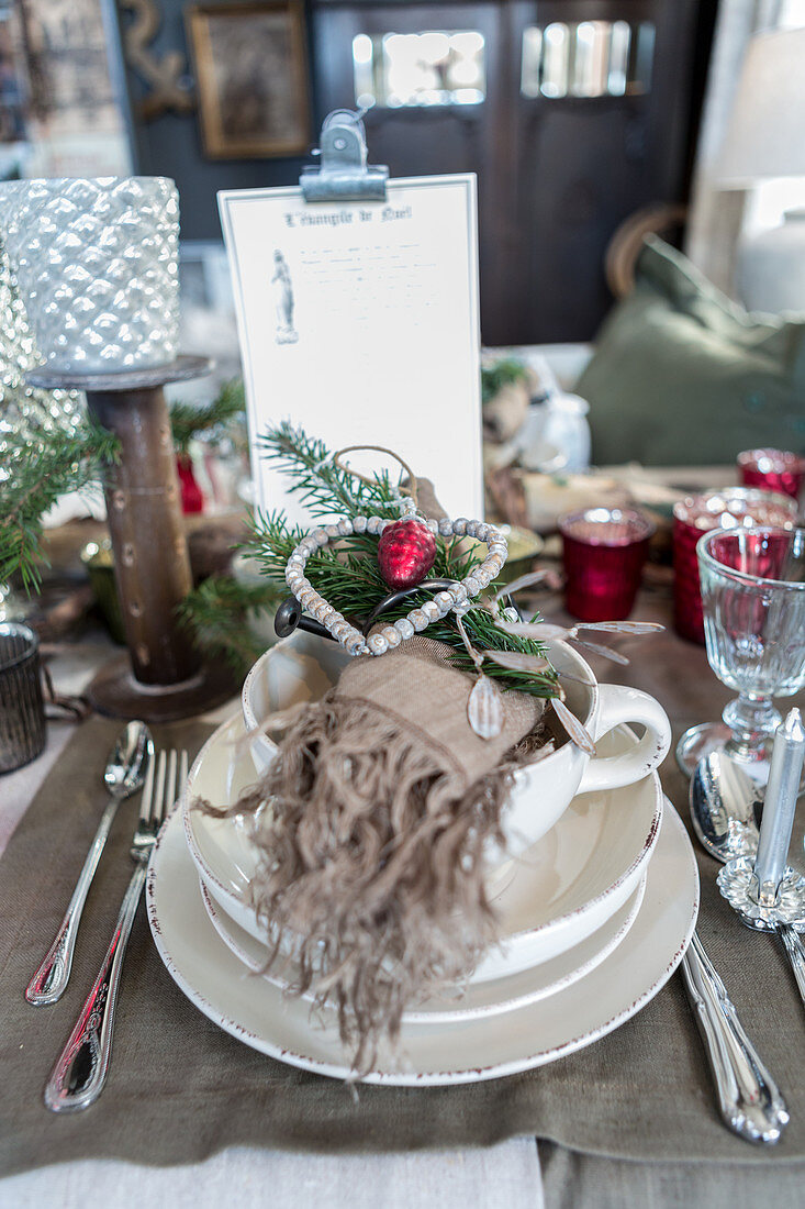 Christmas table lavishly set with many vintage-style decorations