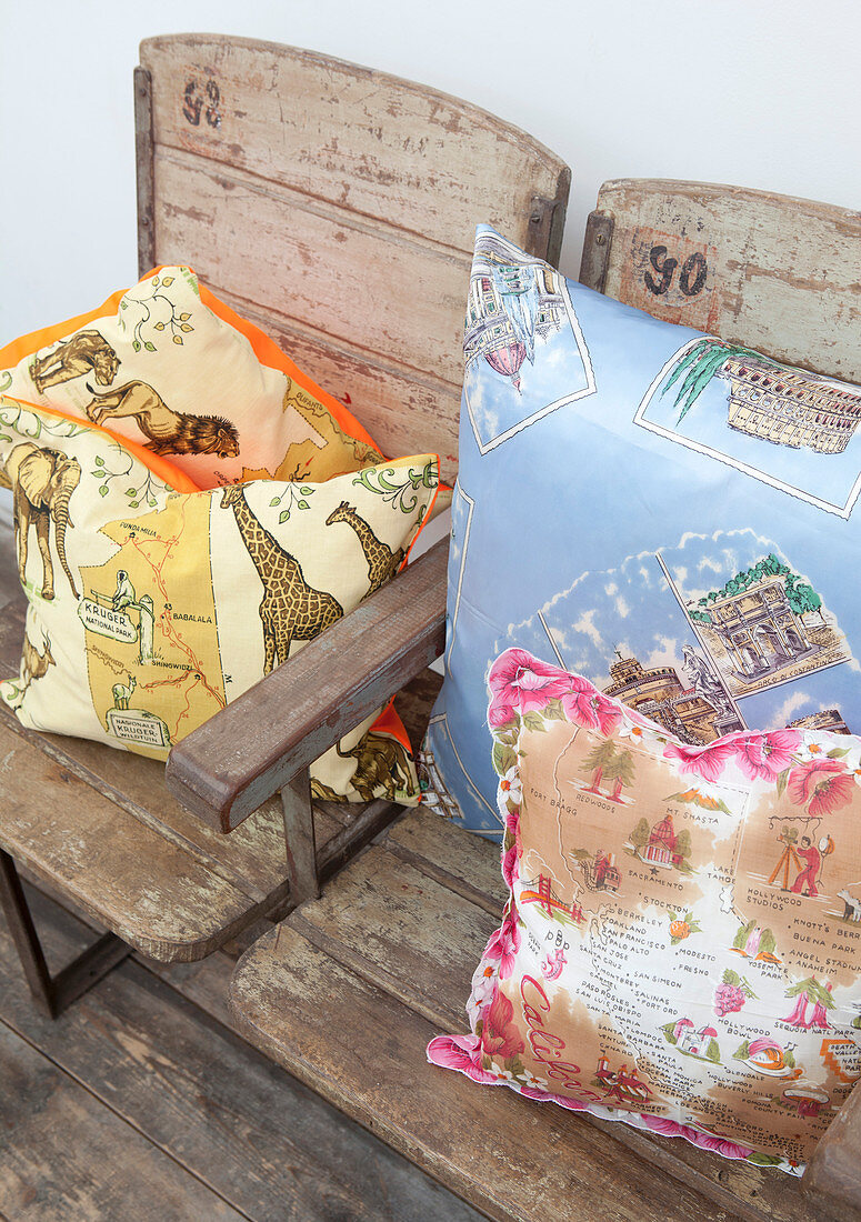 Holiday motifs on cushions on wood and metal bench