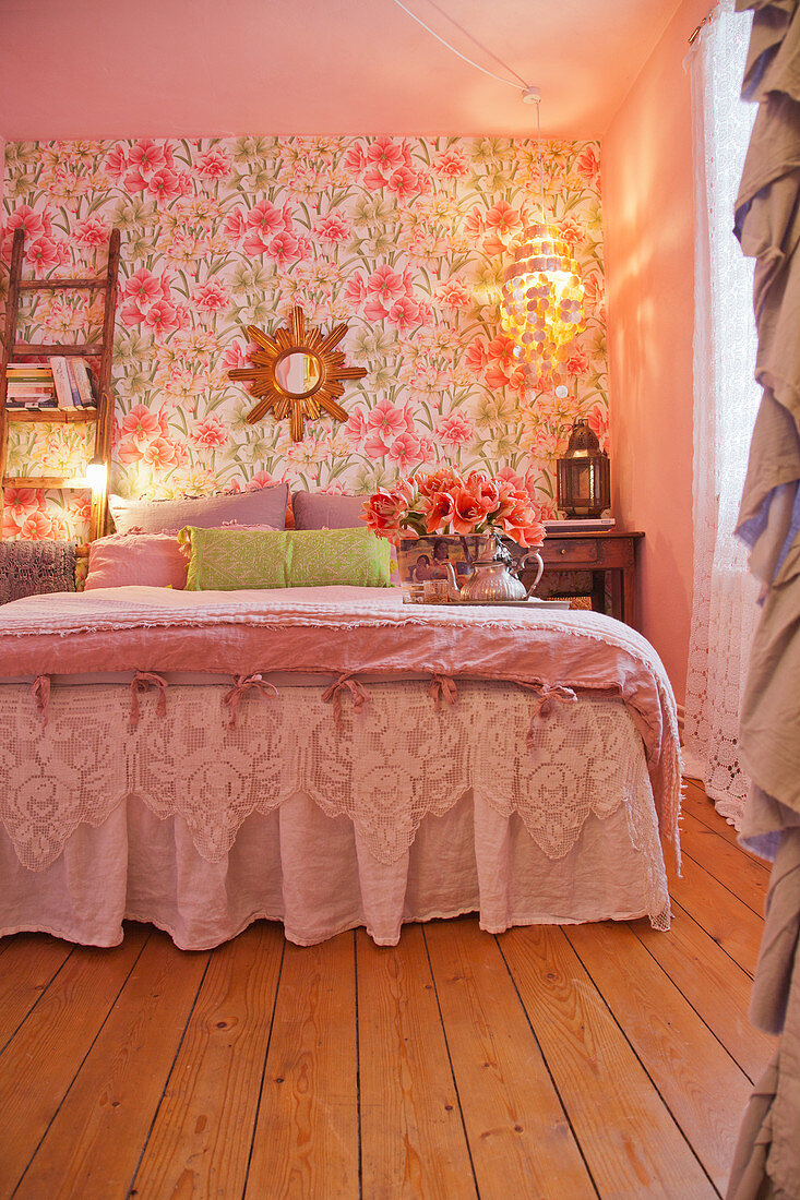 Bed with valance in romantic bedroom with floral wallpaper