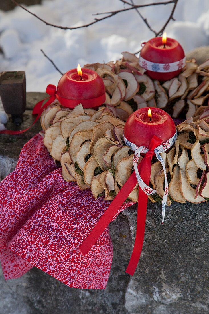 Advent wreath of spherical candles and dried apple rings