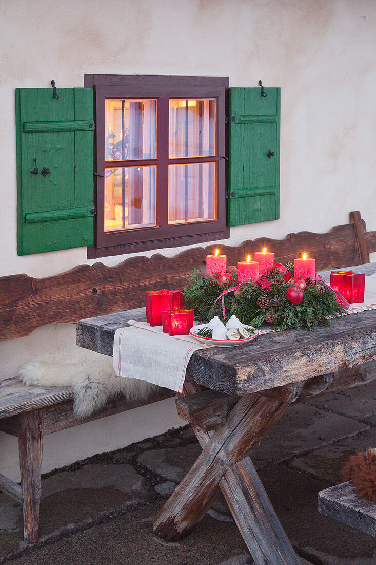 Classic Advent wreath on wooden table outside window