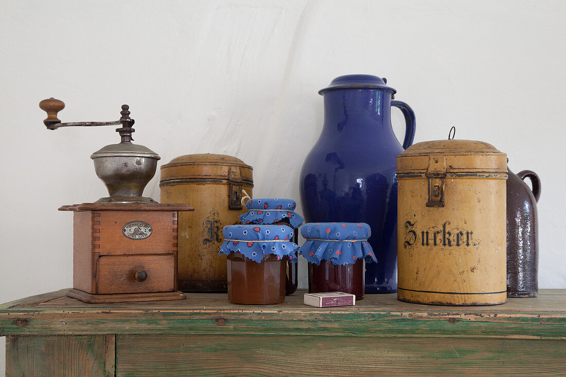 Old kitchen utensils and jam jars with fabric covers