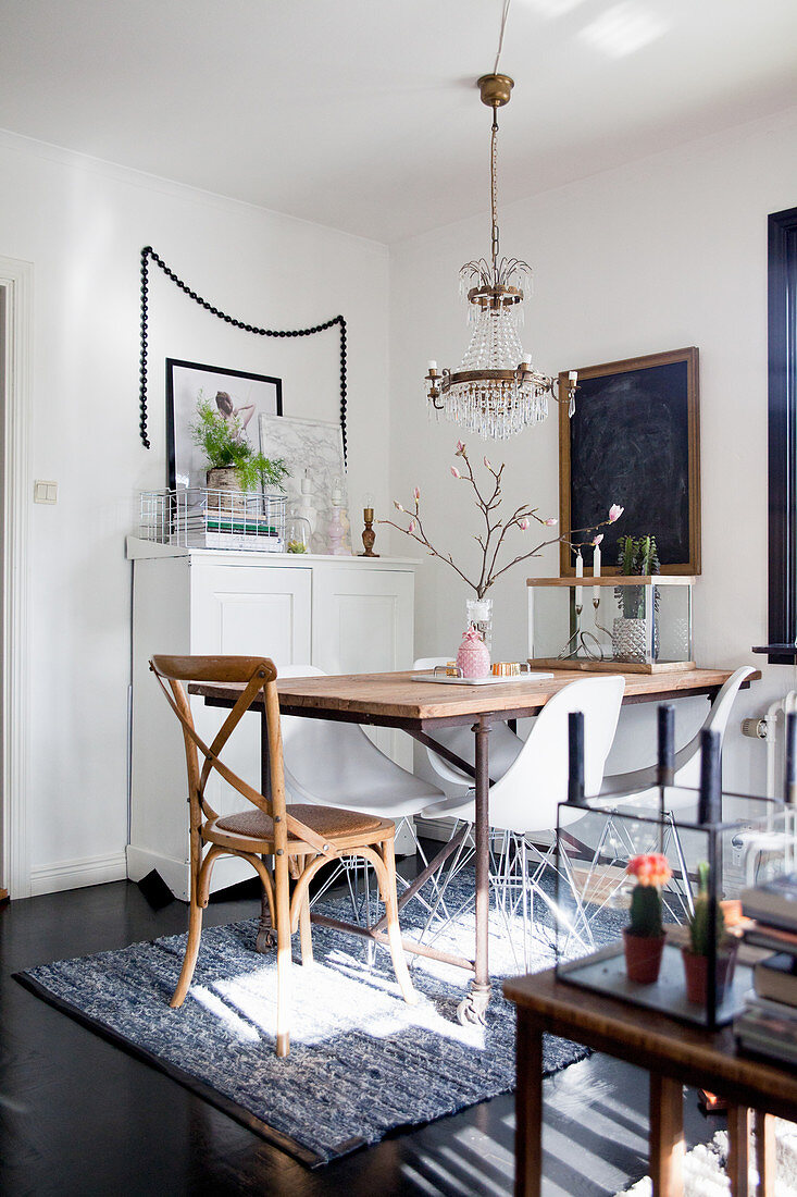 Various chairs at table with metal frame in eclectic dining room