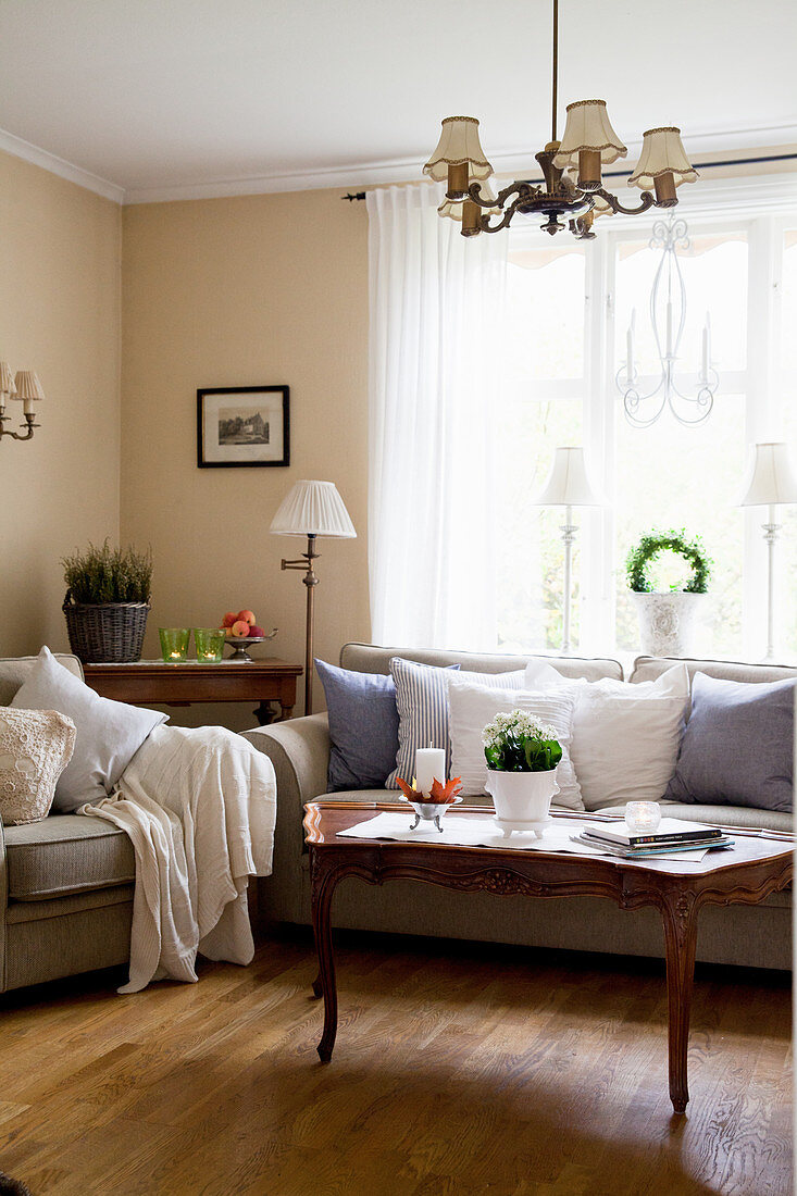 Grey sofa set and antique coffee table in classic living room