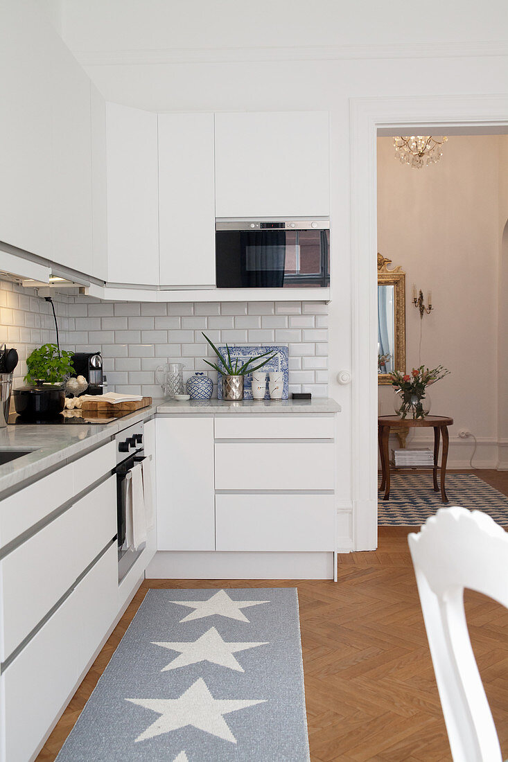 Simple kitchen counter and runner with star motif in open-plan interior