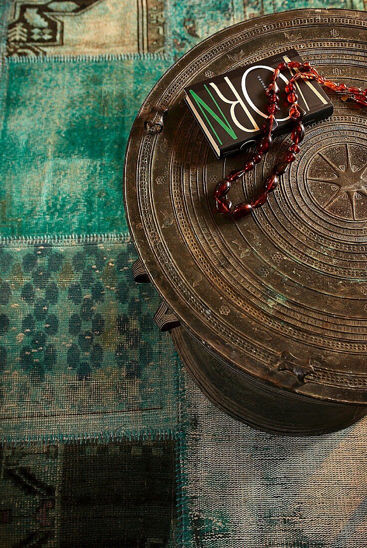 Necklace and book on ethnic table