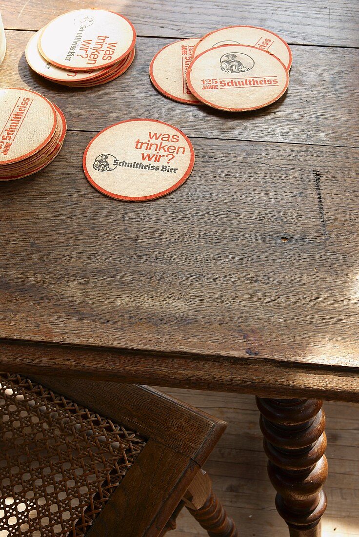 Round beer mats on oak table