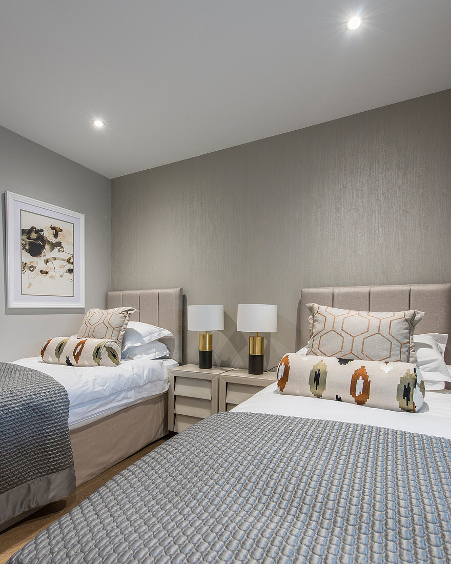 Twin beds in bedroom in shades of grey