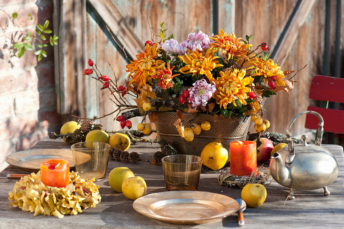 Autumn arrangement in copper jardiniere as table decoration