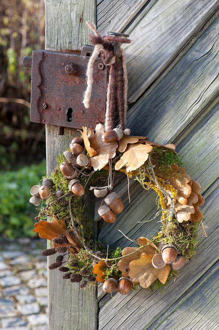 Wreath made of moss, twigs, leaves and Quercus fruits