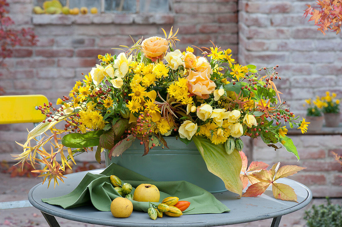 Yellow autumn arrangement in sheet jardiniere