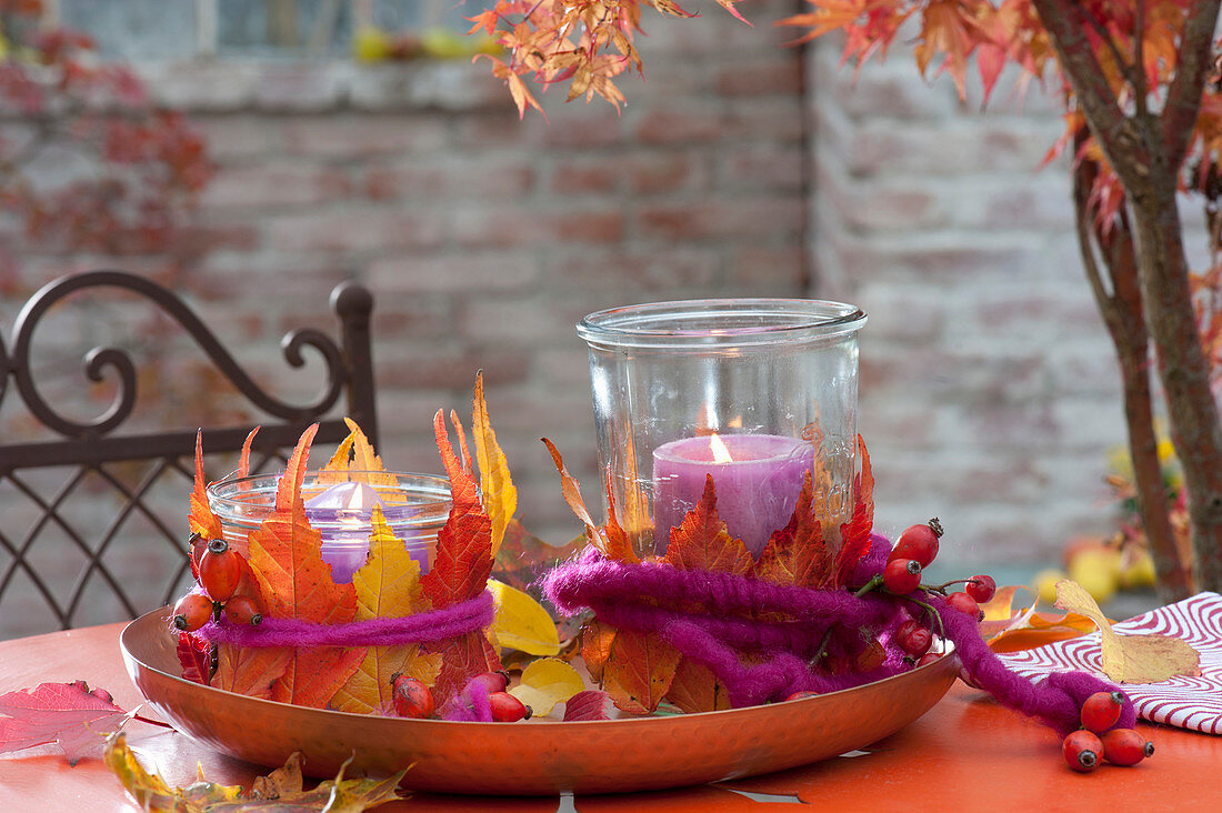 Preserving jars used as lanterns with colorful autumn leaves