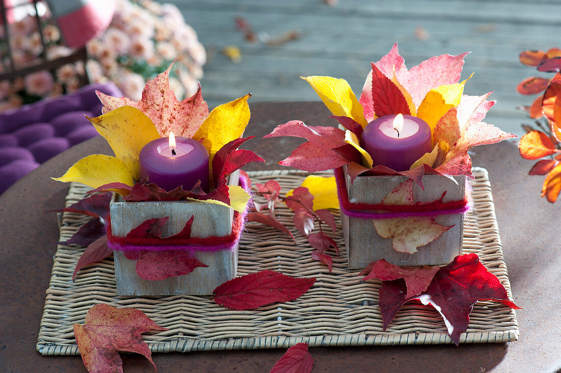 Wooden box with colorful autumn leaves decorated as lanterns