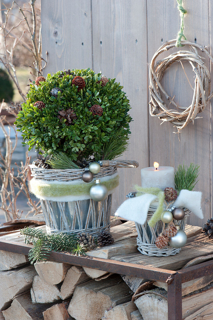 Buxus (box) ball and candle in baskets, decorated