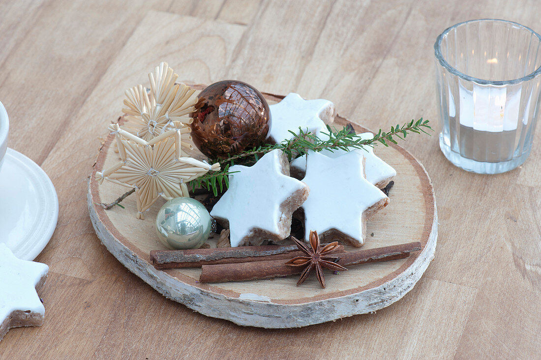 Small Advent and Christmas decoration on birch slice, cinnamon stars