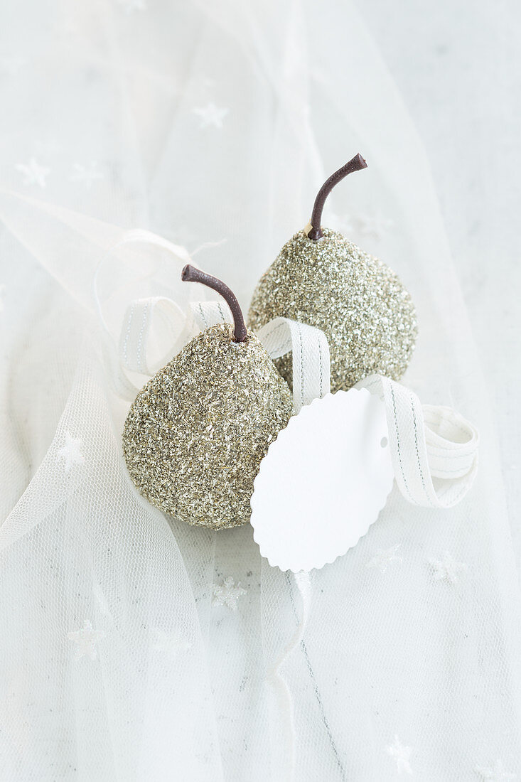Festive arrangement of glittery pears and gift tag