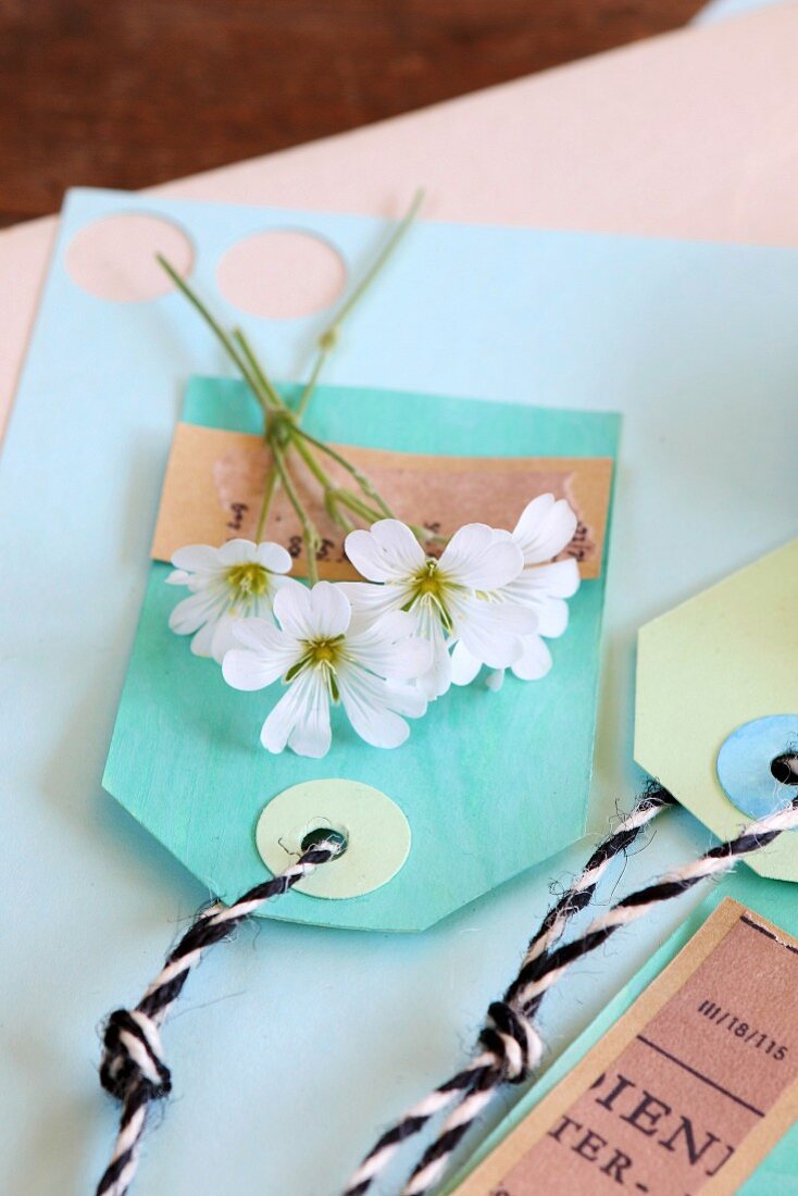 White flowers on hand-made paper tags