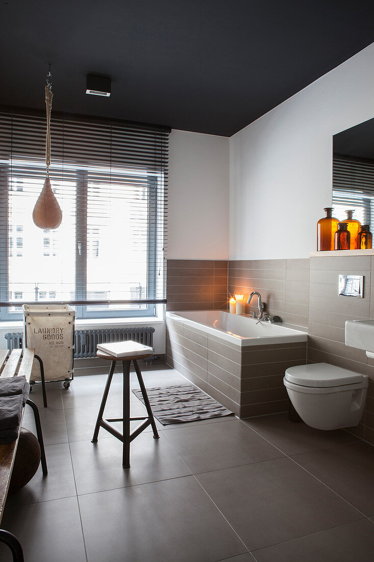 Industrial-style accessories in large bathroom in shades of brown
