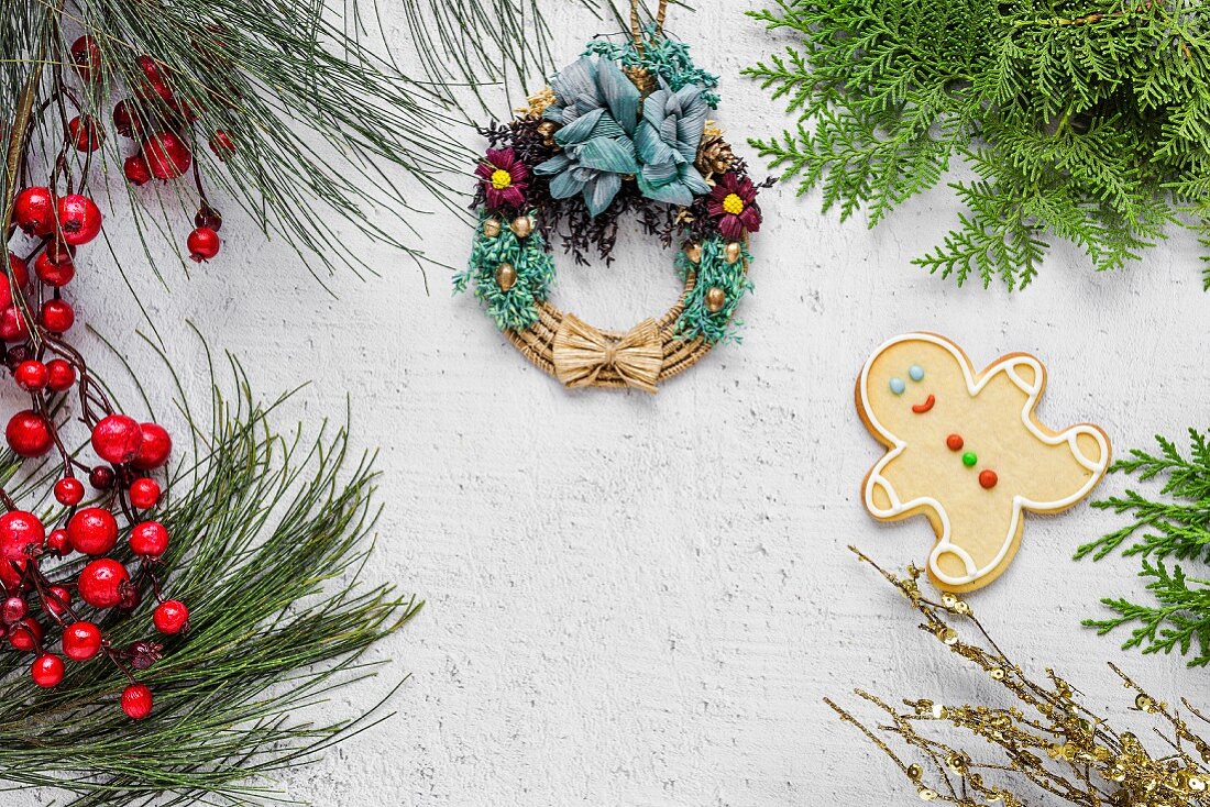 Christmas cookies on wooden table with Christmas decorations and decorated straw wreath