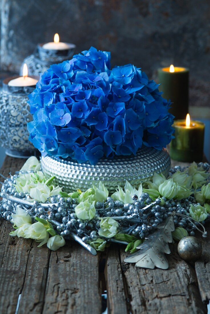 Blue hydrangeas in wreath of silver berries and yucca leaves