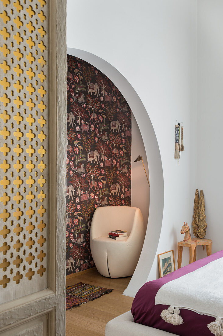 Round open doorway in bedroom with exotic accessories