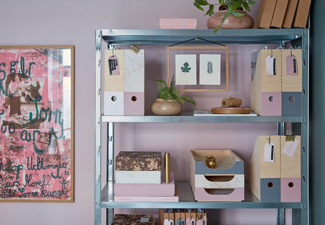 Decoupaged and painted filing system on metal shelves