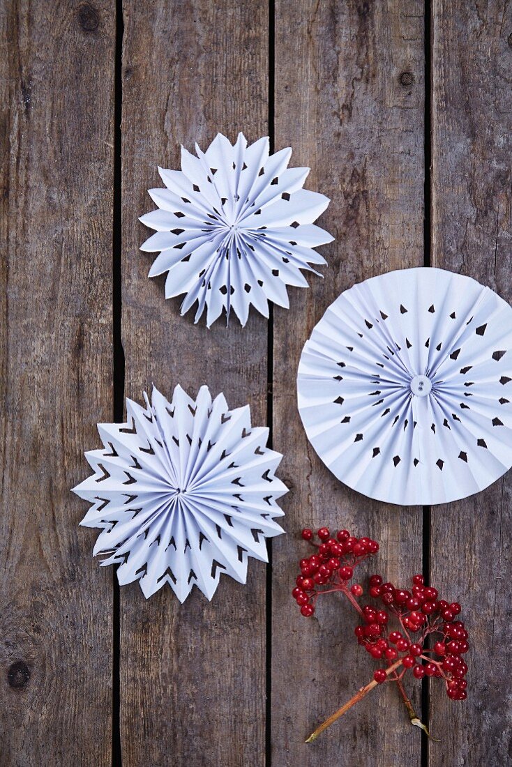 White paper rosettes on rustic wooden boards