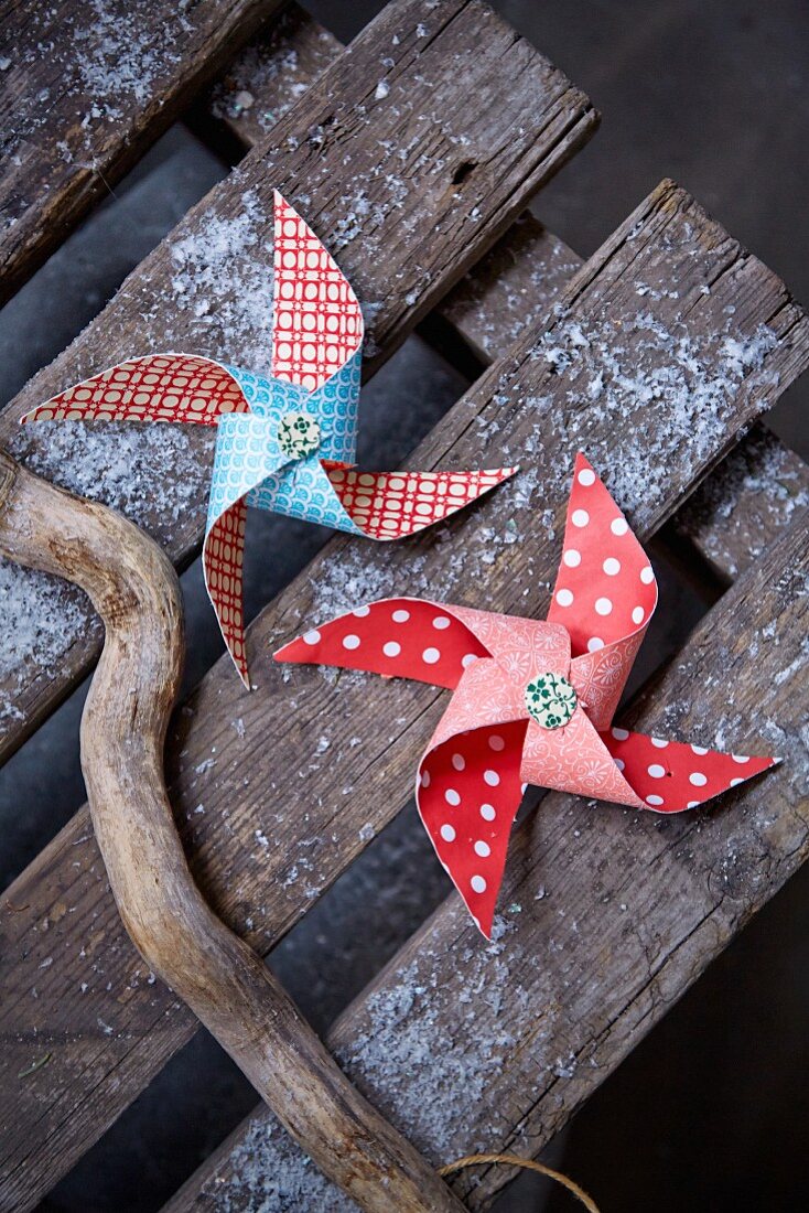 Patterned paper windmills on weathered wooden boards