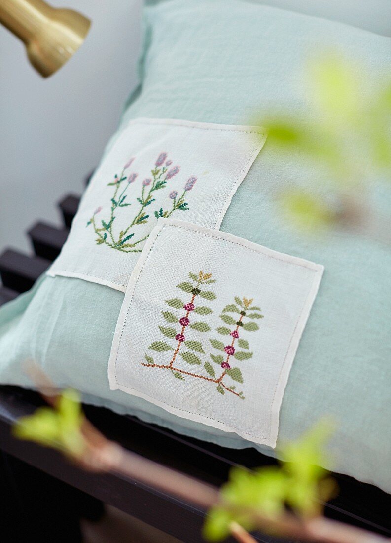 Cushion with floral embroidered panels