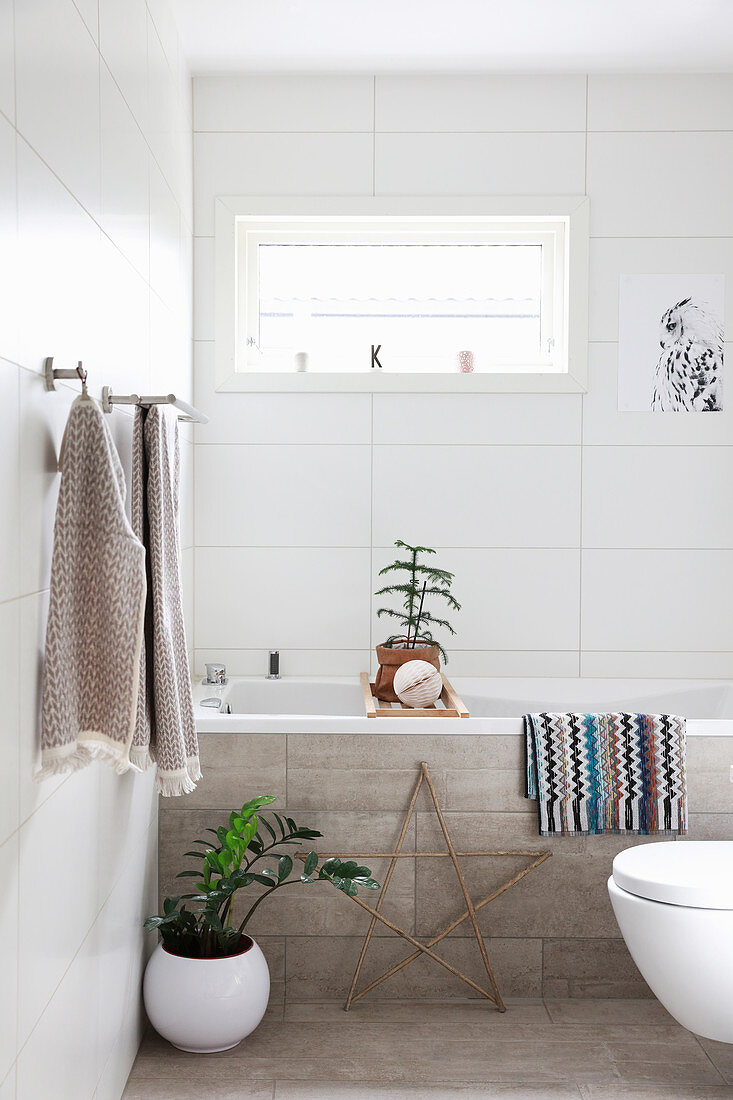 Christmas decorations in bright bathroom with concrete tiles