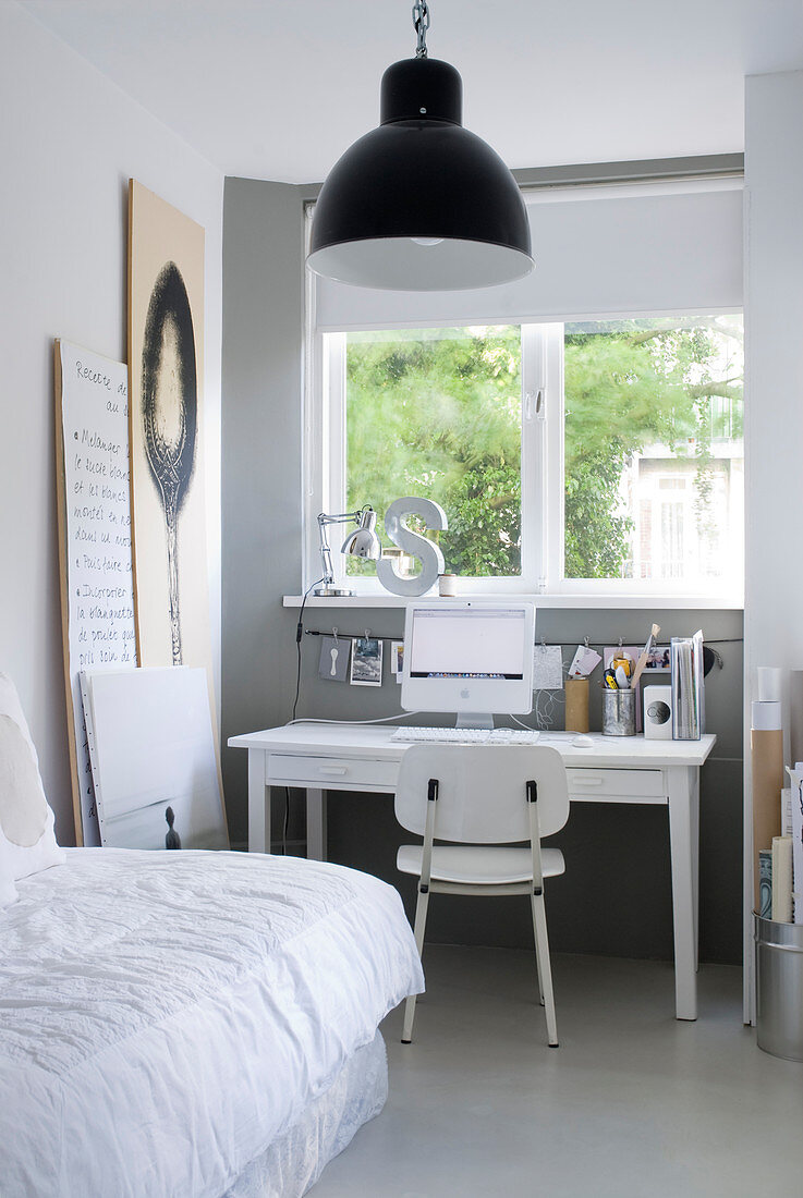 Desk below window in grey-and-white bedroom