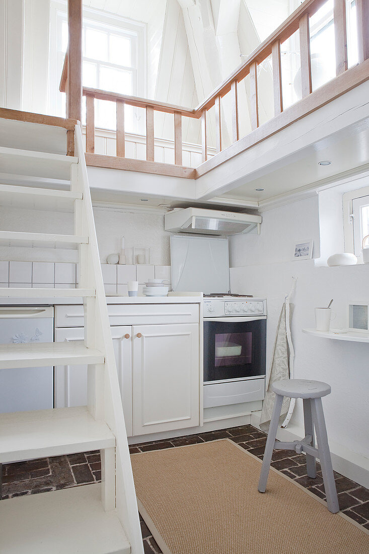 White kitchen below gallery