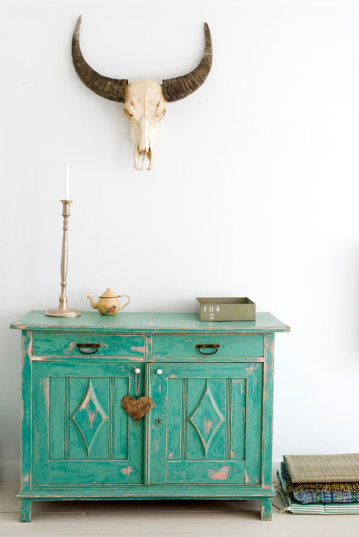 Hunting trophy above turquoise, shabby-chic cabinet