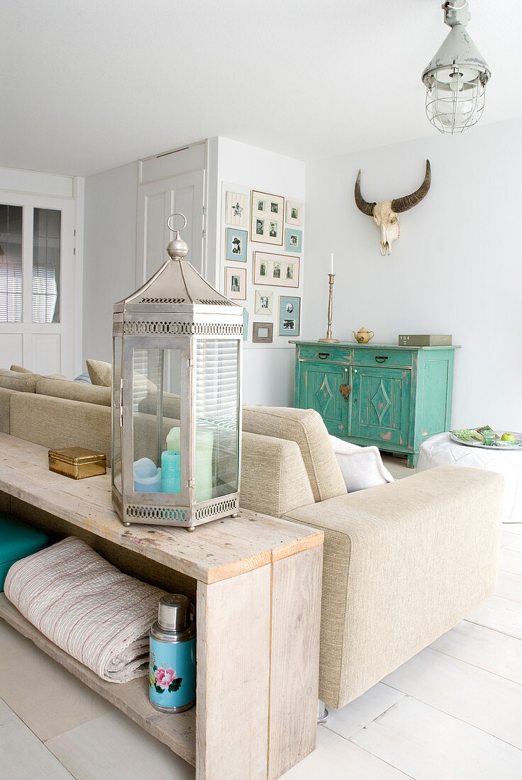 Rustic wooden sideboard used as partition behind sofa